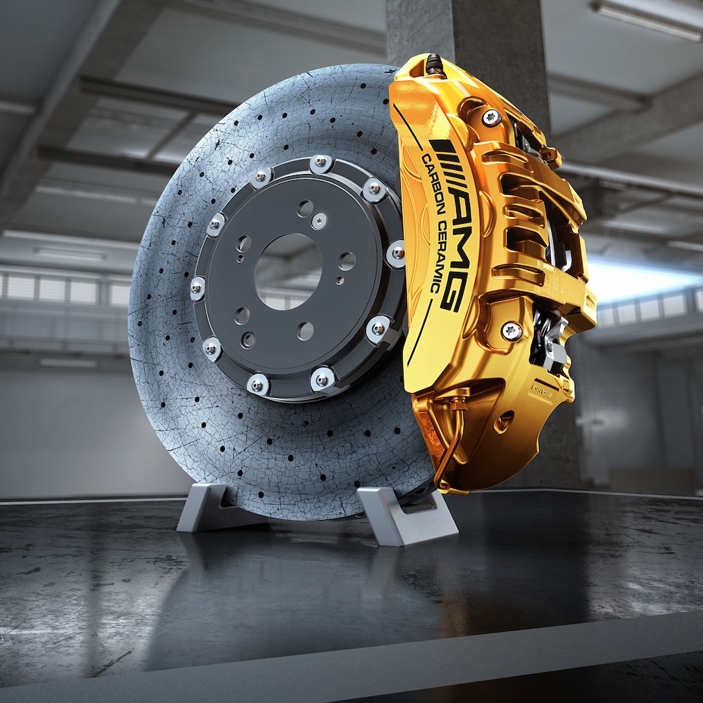 Close-up of a AMG light-alloy wheel with AMG high-performance ceramic composite braking system shining through.