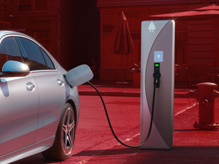 The Mercedes-Benz C-Class Saloon plug-in hybrid charging at a public charging station.