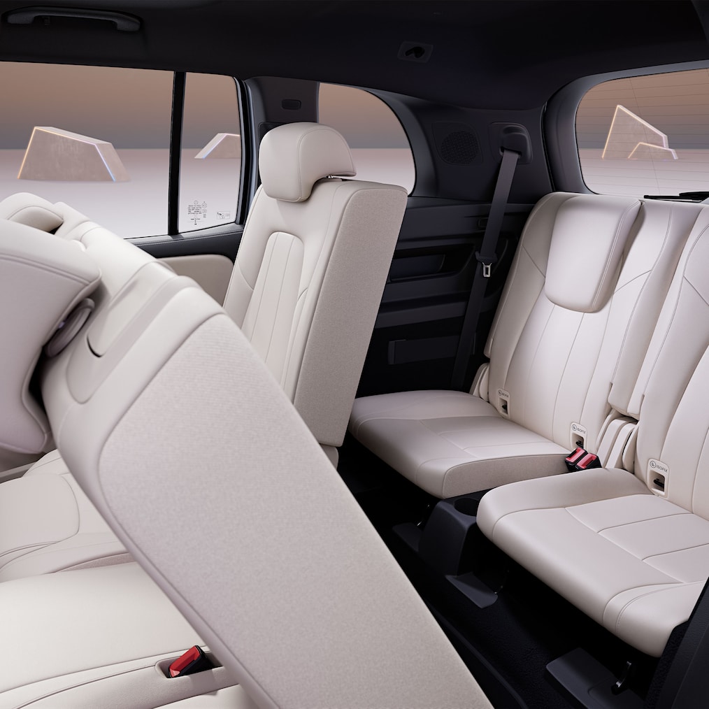 View through the open rear side door with 2nd and 3rd row of seats.