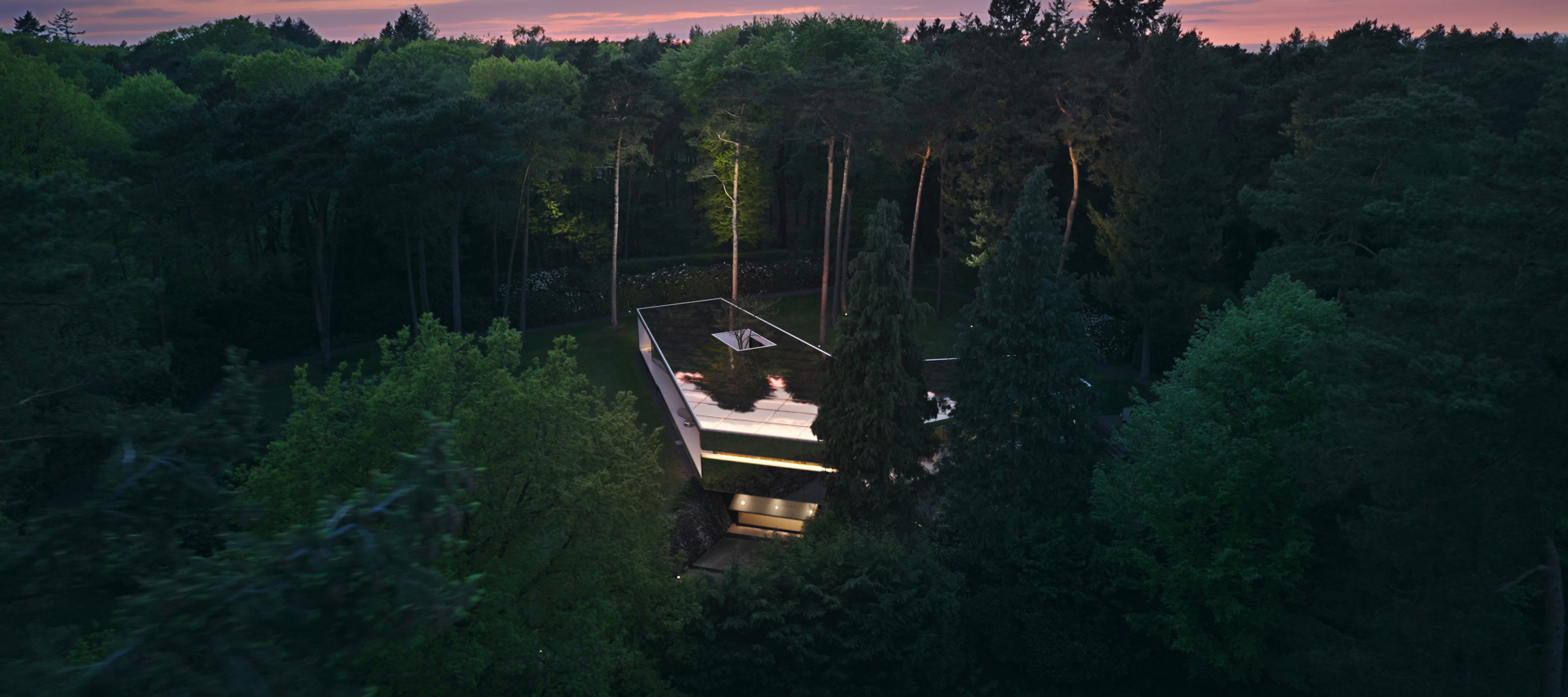 Electromobility and innovations from Mercedes-Benz A white suburban architect house with a driveway and a garage.