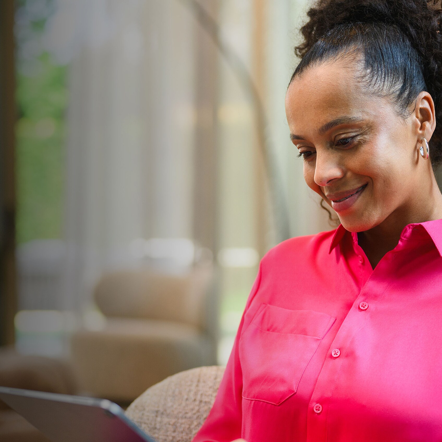 A person sitting on a sofa and using their mobile device. 