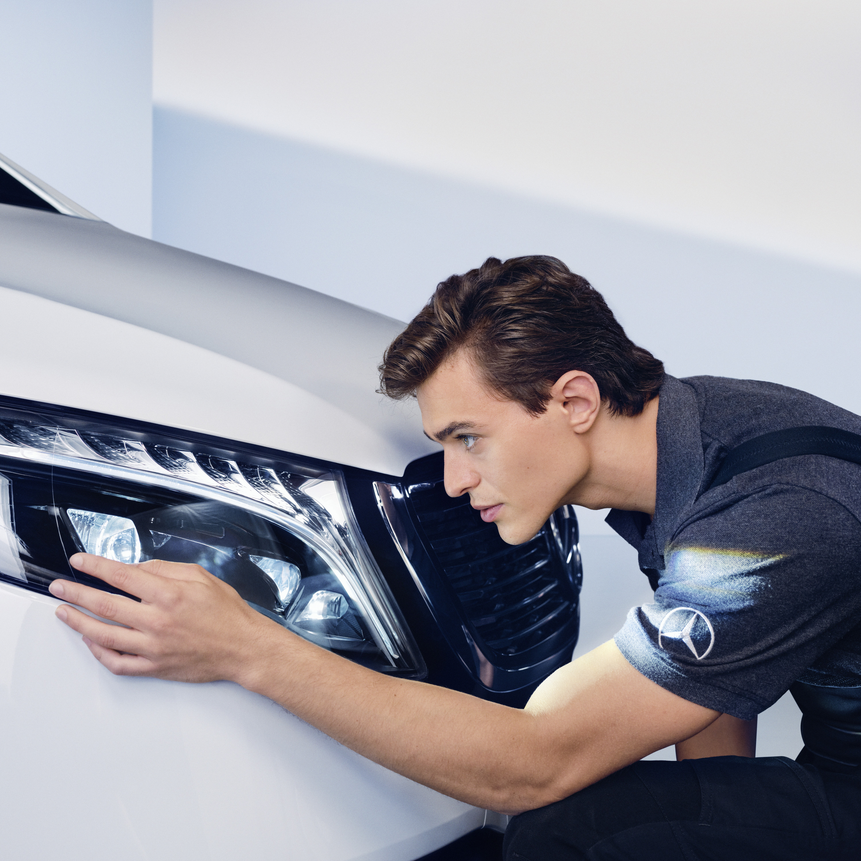 SmallRepair | Mercedes-Benz A service technician checking the headlight of a Mercedes-Benz.