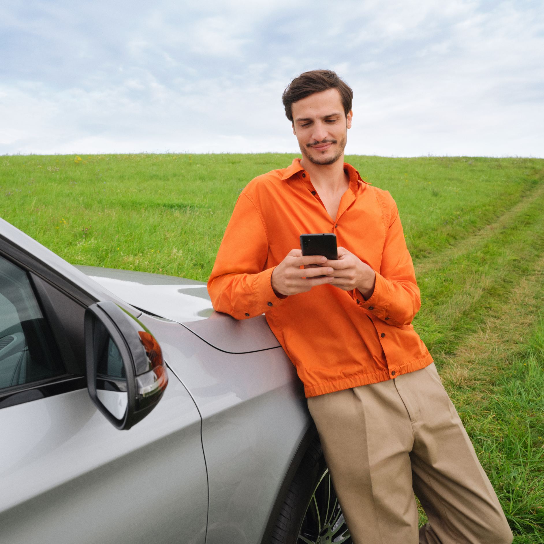 A man connects his smartphone to his vehicle to use the Standard Services. A man connects his smartphone to his vehicle to use the Standard Services.
