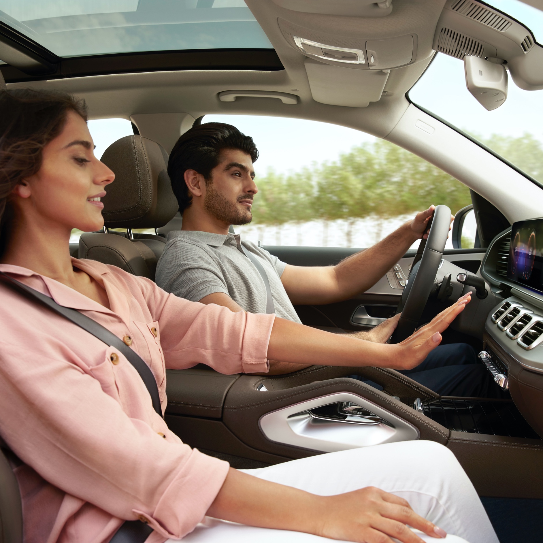 Mercedes-Benz genuine air filters A woman raises her hand in front of the air conditioning vents in her Mercedes-Benz.