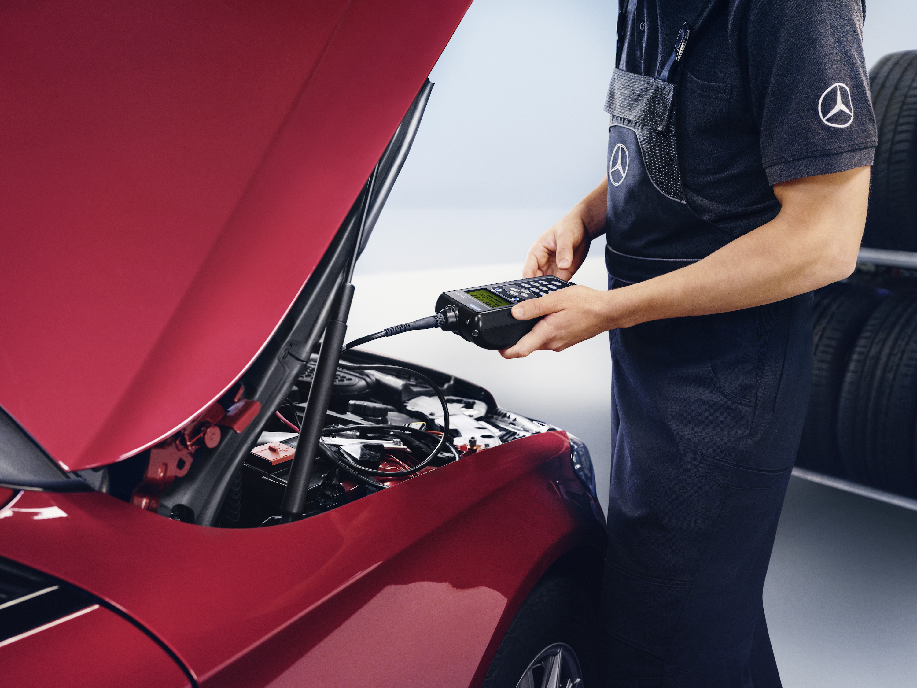 Mercedes-Benz genuine on-board power supply batteries A Mercedes-Benz technician checks the vehicle's electrical system battery.
