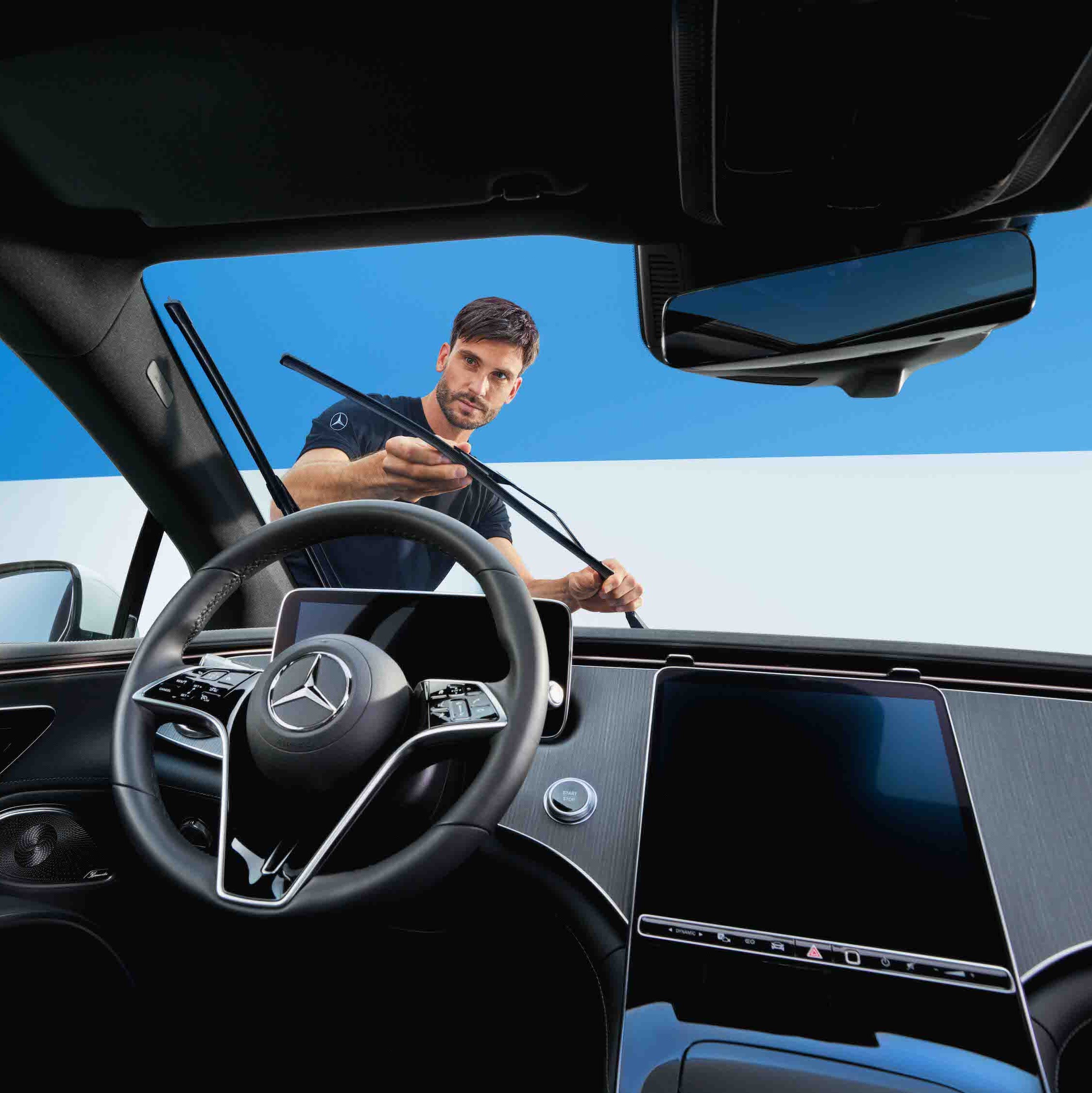 A Mercedes-Benz technician changes the windscreen wipers on the vehicle.