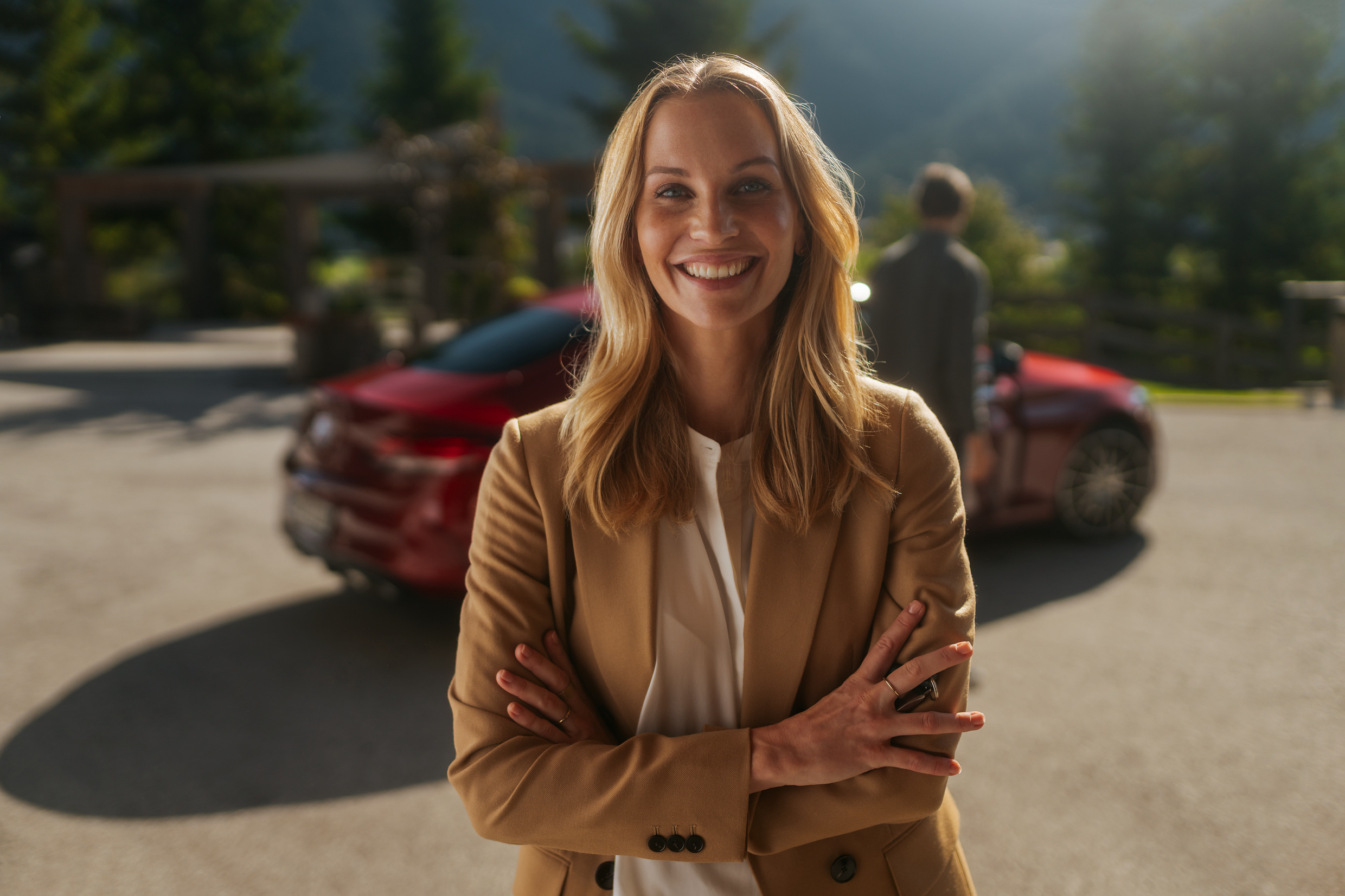 A pleasant journey with the Mercedes-Benz warranty for new vehicles. | Mercedes-Benz A woman, standing in front of her Mercedes and looking in a good mood.