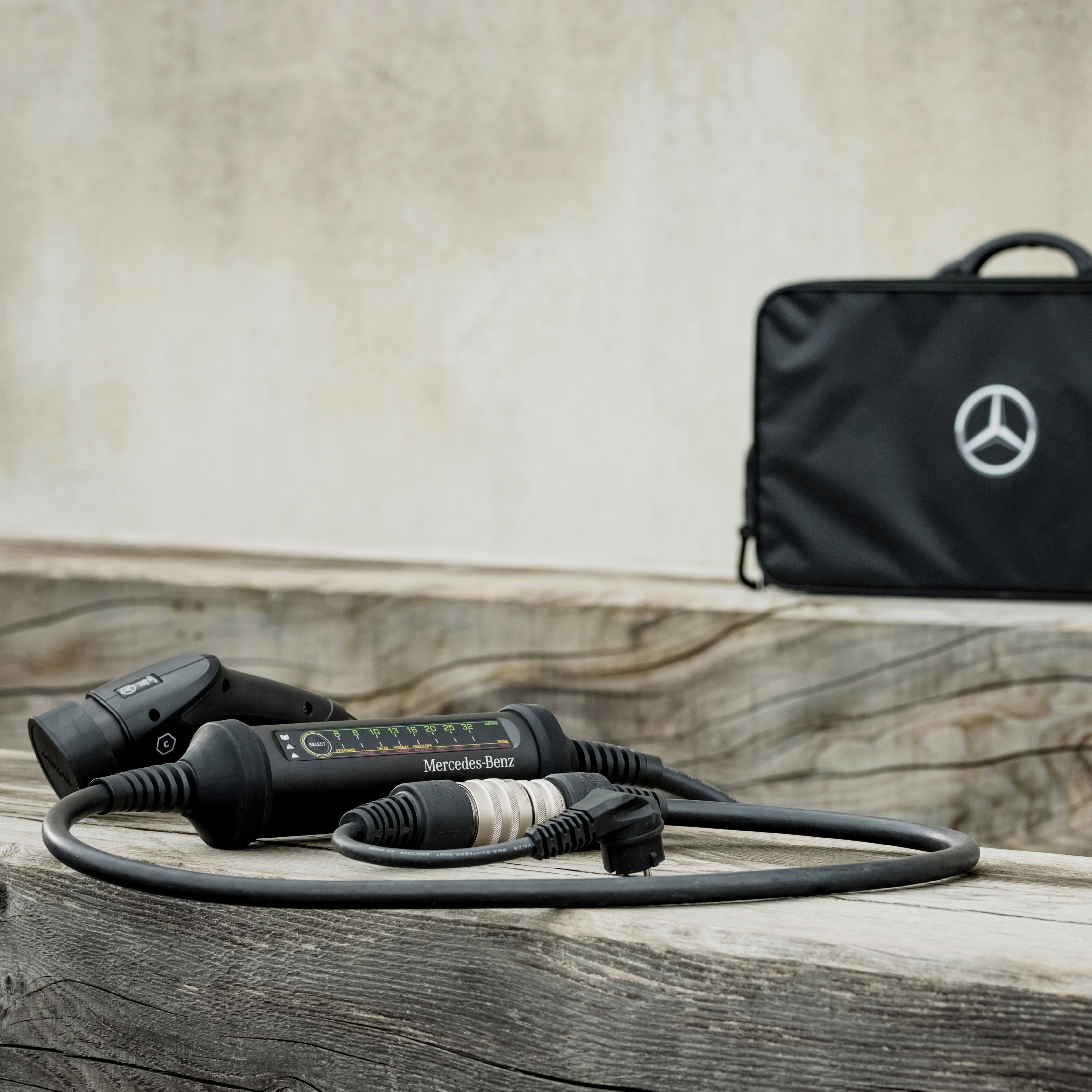 The Mercedes-Benz Flexible Charging System is hidden within a bag with Mercedes star motif