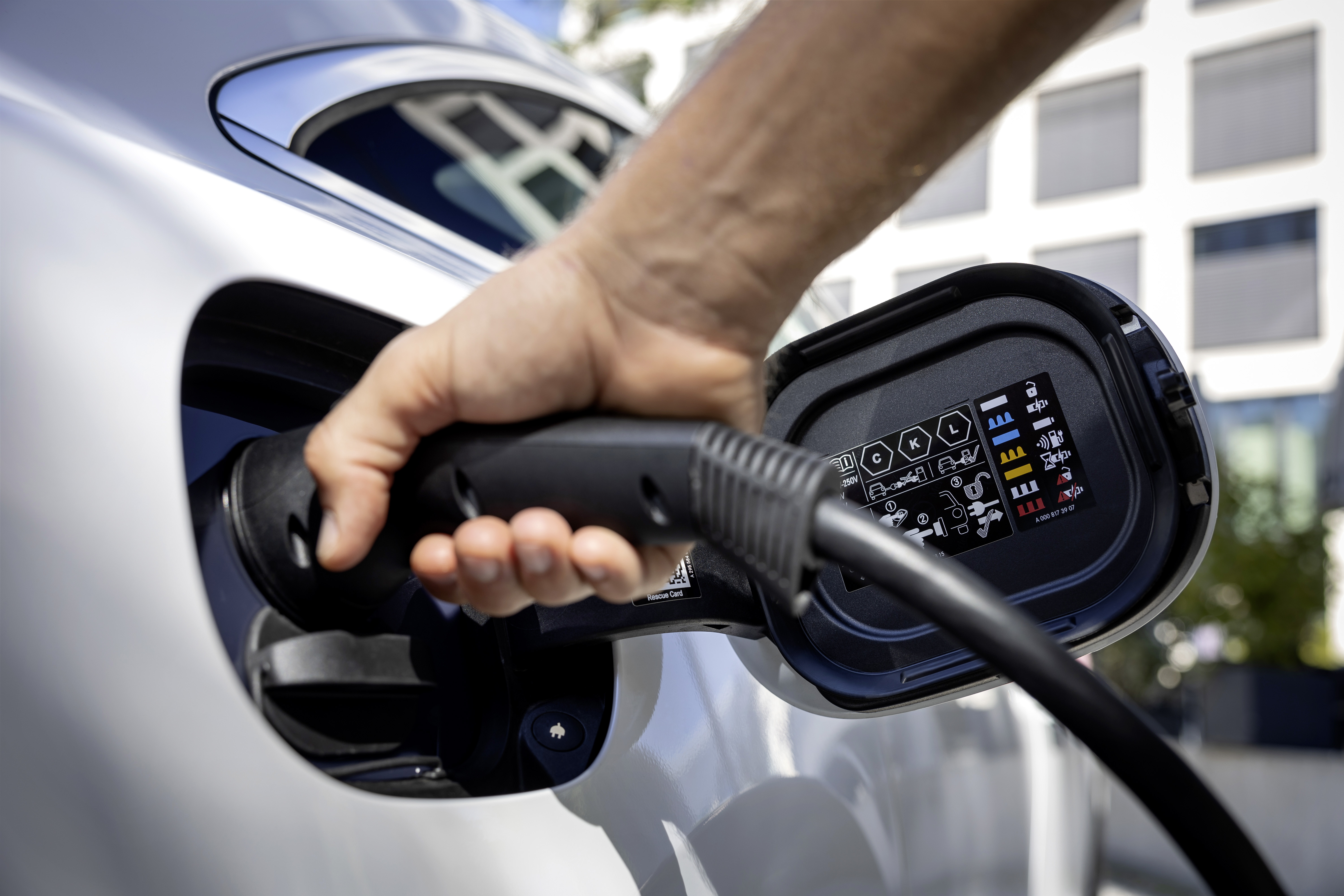 Charging via a type 2 connector A hand holding a type 2 connector that is connected to an electric car