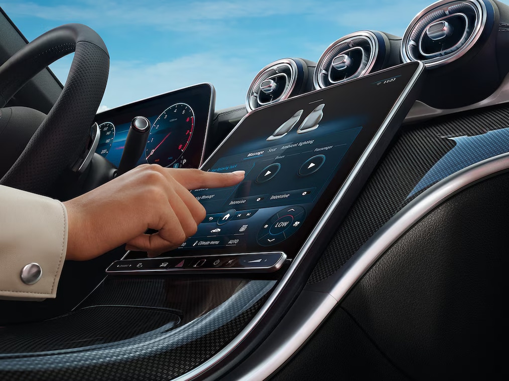 Dynamic view of a Mercedes-Benz C-Class Saloon (driving shot) or standing at a charging station.