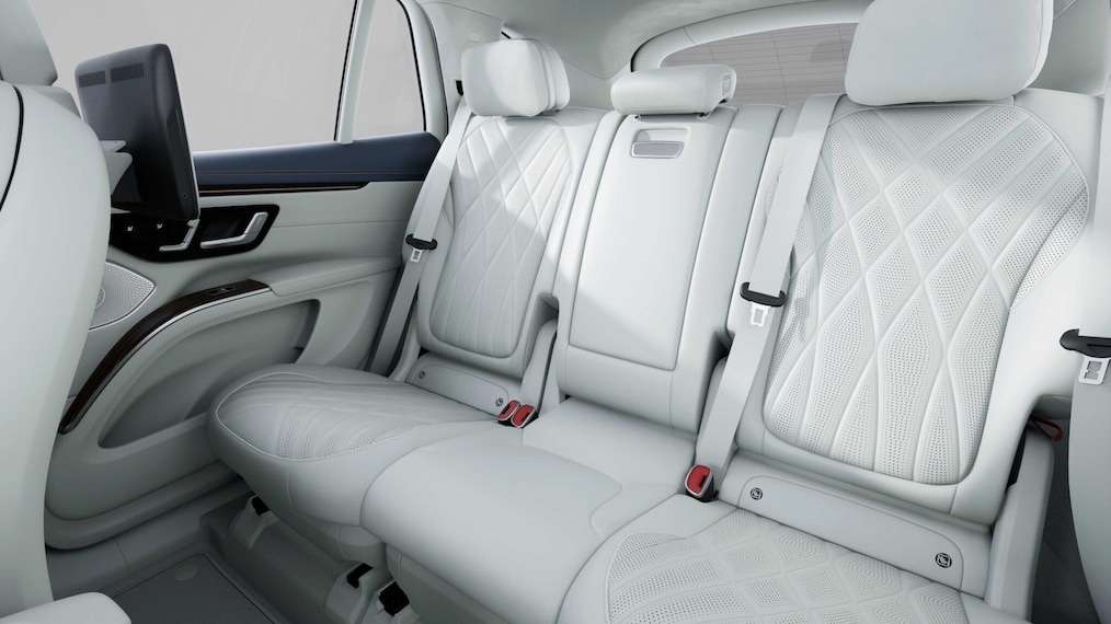 A view of the two rear rows of seats of the EQS SUV with the rear side door open.